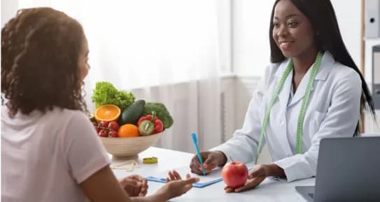 A dietitian discusses a meal plan with a patient