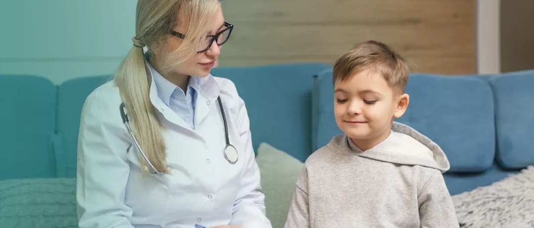 A doctor talks with a young boy