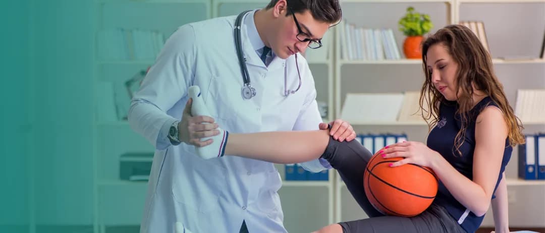 A doctor examines a basketball player’s shoulder